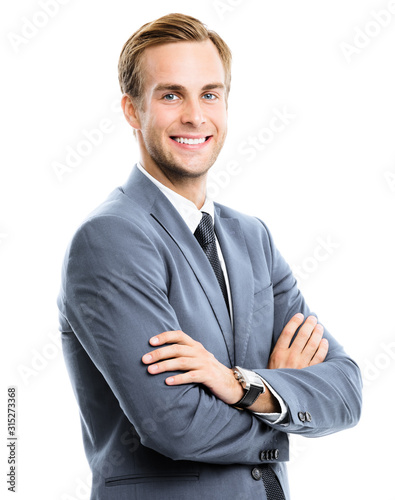 Portrait picture of happy smiling businessman in grey confident suit, crossed hands, isolated on white background. Business success concept.