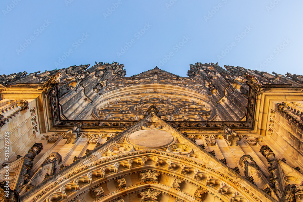 Arch above entrance of St. Vitus Cathedral with blue sky