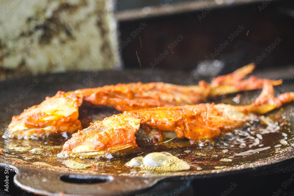 Frying Roasting Delicious Tasty Marinated Fish Dip in Hot Oil On Indian Tawa