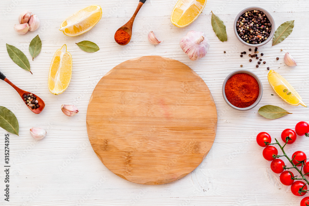Mockup for menu. Cutting board near spices and vegetables on white background top-down