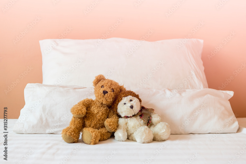 Cute brown and white teddy bear sitting together on the bed, love and romance concept, valentine background idea