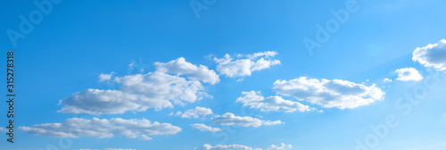 Beautiful blue sky with white clouds and sun, sunlight background © Thicha