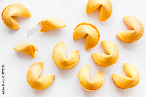Fortune cookie background on white table top-down