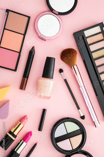 Make up cosmetics products against pink color background photo