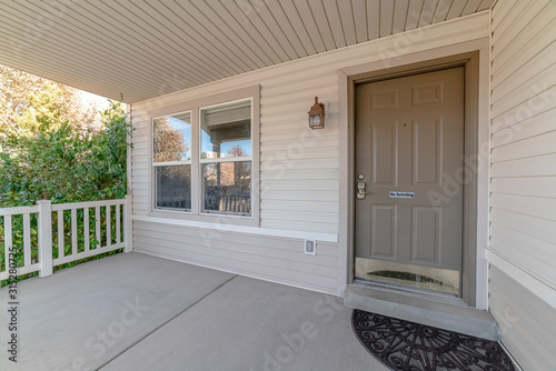 Covered front porch with grey and white decor