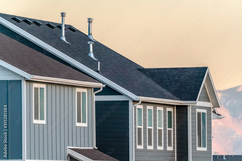 Grey timber house facade at sunset day light Grey timber house facade at sunset day light