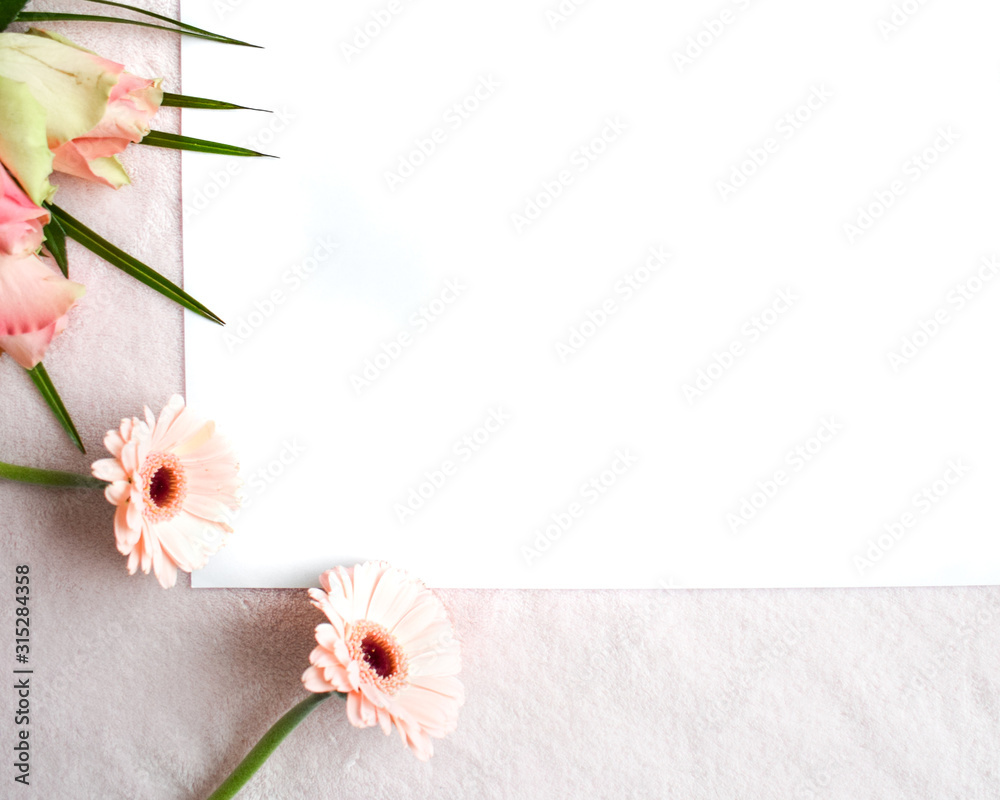Lifestyle flat lay: Bouquet of wild flowers white table background. Pink rose tone. Open book, pencil, white. Top view, empty space for publicity information or advertising text. Mock-up. Copy space.