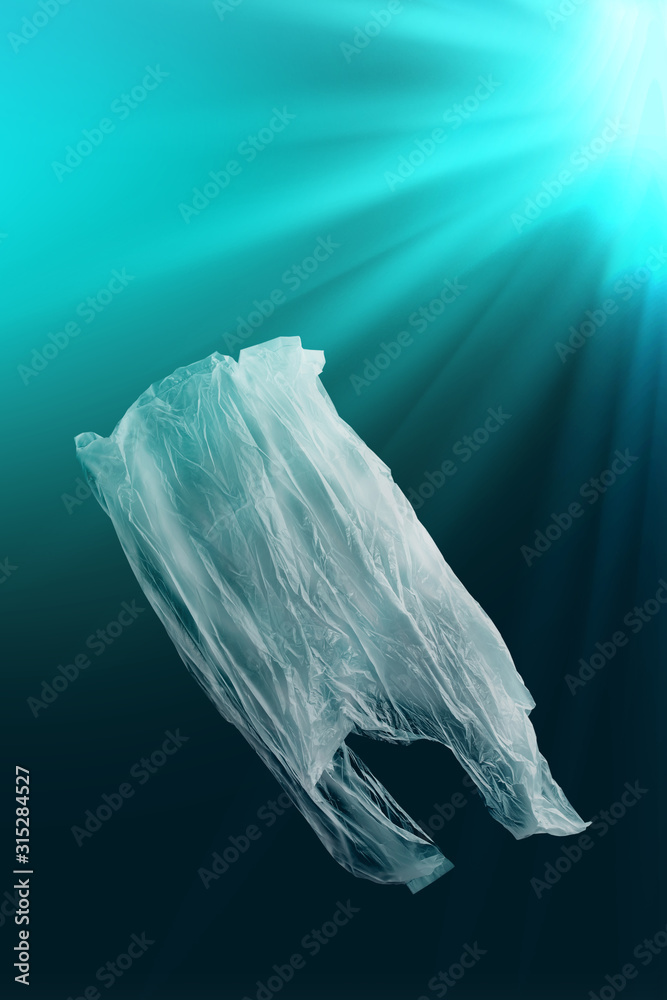 creative background of singleuse plastic bag floating in sea or ocean