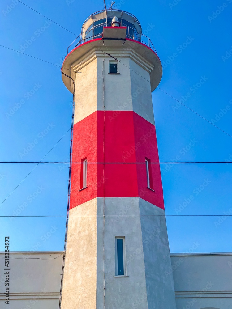 lighthouse on background of blue sky