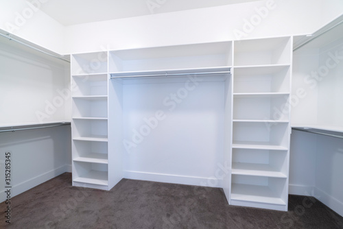 Empty fitted interior of a walk-in closet