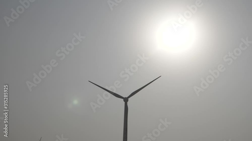 Windmill in Pakistan Gharo Sindh with Sun in background photo