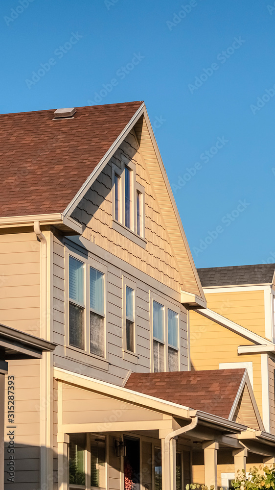 Vertical Row of double storey timber clad homes Vertical Row of double storey timber clad homes