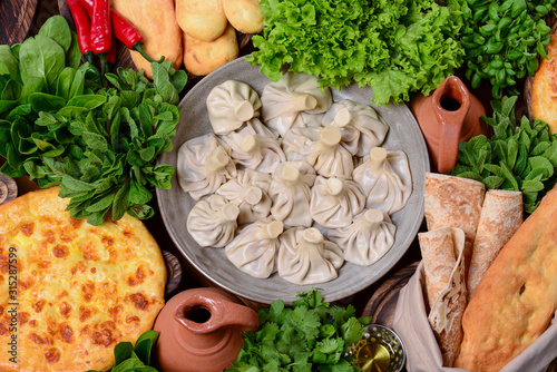 Top view of traditional Georgian cuisine: Kolkh and Adjara khachapuri, khinkali dumplings, shotis puri, kubdari or kubed