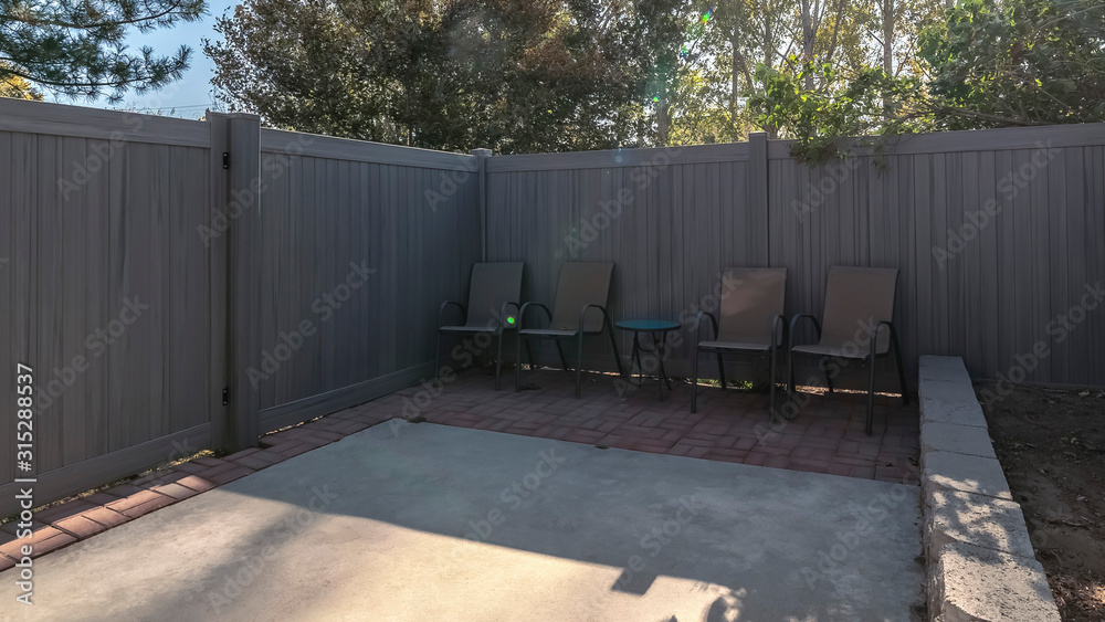 Panorama Small enclosed yard with high fence and gate Panorama Small enclosed yard with high fence and gate