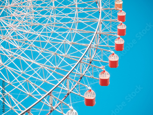 Ferris Wheel Over Blue Sky Background