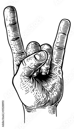 A hand doing a heavy metal rock music sign gesture in a vintage woodcut retro style