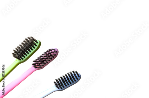 multi-colored toothbrushes with black bristles on a white background.