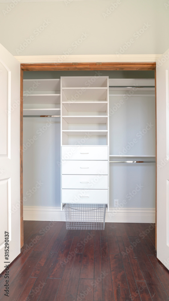 Vertical Interior of an empty walk-in closet in a new house