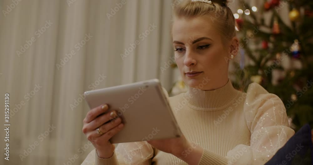 Woman Using Digital Tablet on Christmas Woman Using Digital Tablet on Christmas