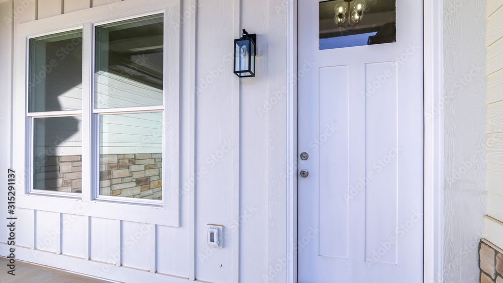 Fototapeta premium Panorama Large square window alongside a white door