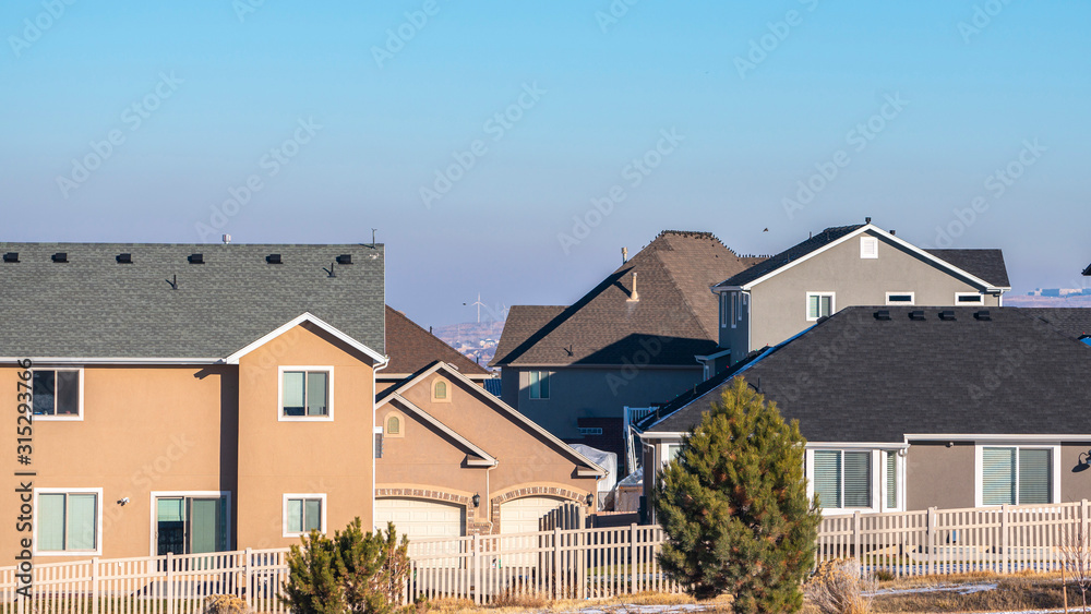 Panorama American houses with white fencing in winter