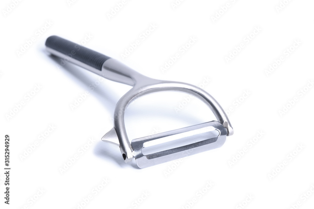 Vegetable peeler metal isolated in different poses on white background Vegetable peeler metal isolated in different poses on white background