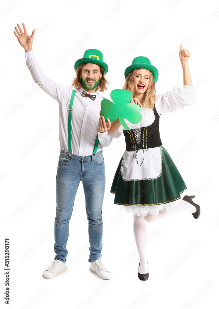 Young couple with paper shamrock on white background. St. Patrick's Day celebration