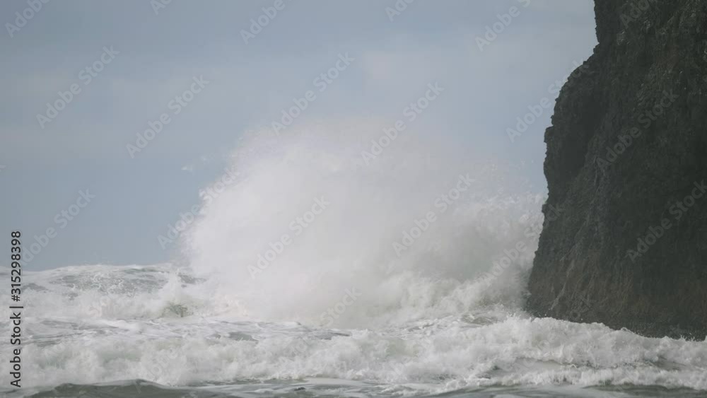 Big storm waves weather pacific ocean hitting crashing into cliff rock blue sky slow motion Pacific Northwest Oregon Big storm waves weather pacific ocean hitting crashing into cliff rock blue sky slow motion Pacific Northwest Oregon