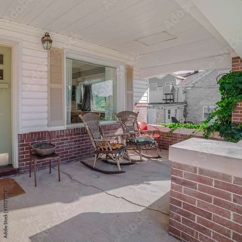 Square Covered front porch with rocking chairs day light