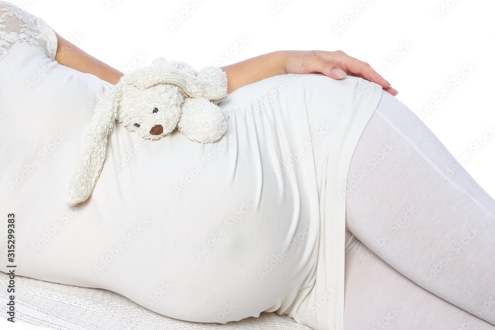 Happy pregnant girl lies on white background Happy pregnant girl lies on white background