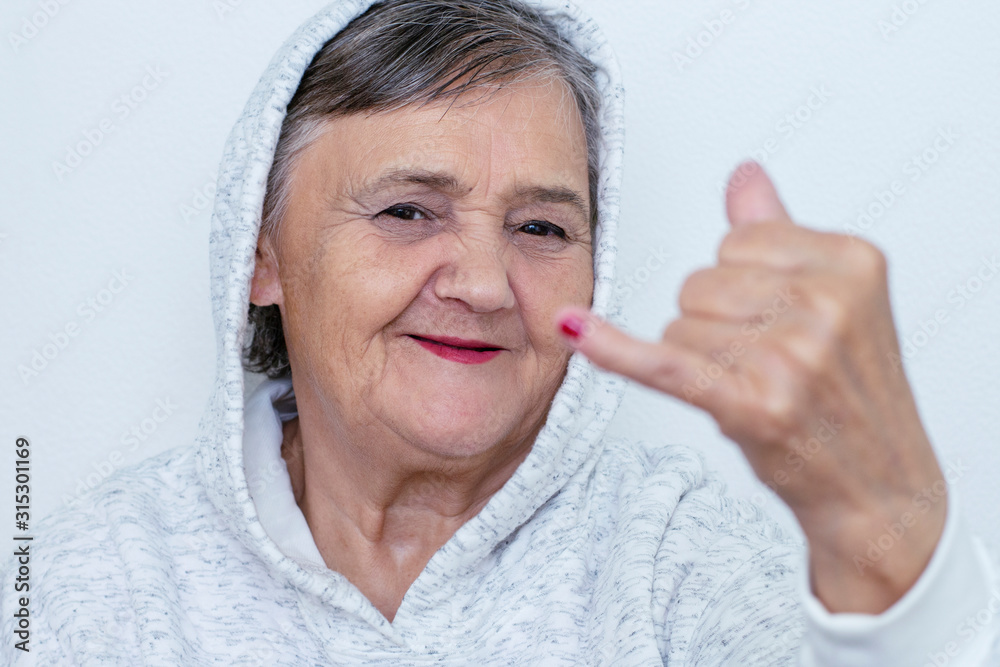 Funny grandma's portraits. The old lady makes a hipster the hand gestures.  Fashion hipster woman having fun. Funny moments with a granny woman.  Lifestyle and people concepts Stock Photo | Adobe Stock