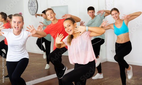 Teenagers training dance in choreography class