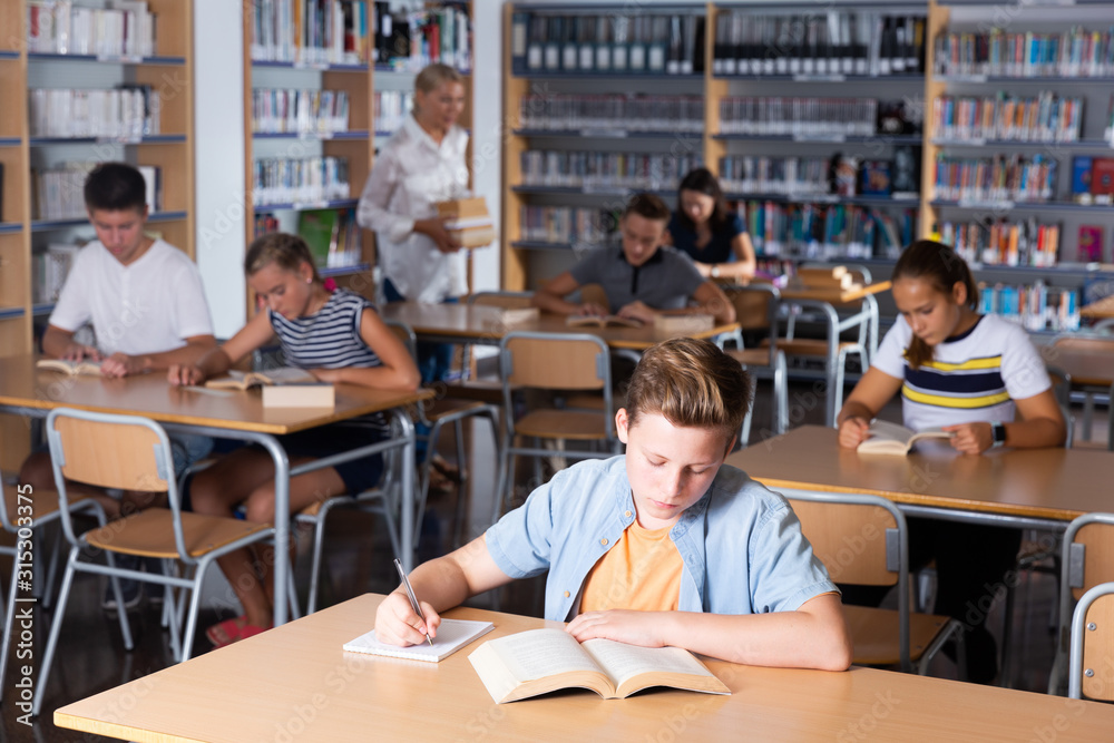 Teenagers  in school library