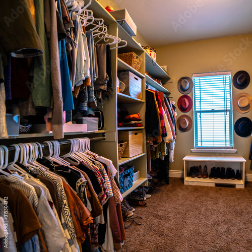 Square Neat walk-in closet full of clothes day light