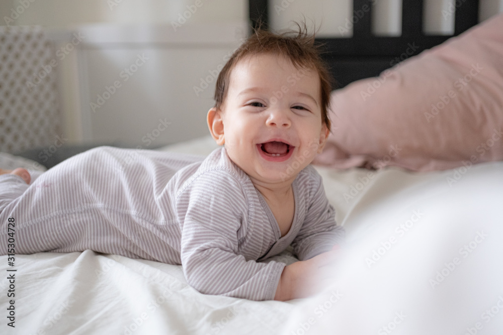 Little cute infant baby portrait in gender neutral clothes smiling Little cute infant baby portrait in gender neutral clothes smiling