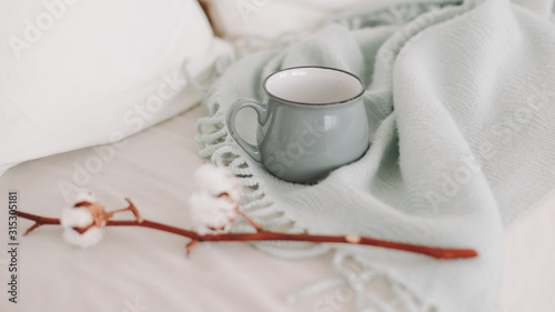 Coffee cup and cotton twig. Breakfast in bed. Cozy home. flat lay  still life.
