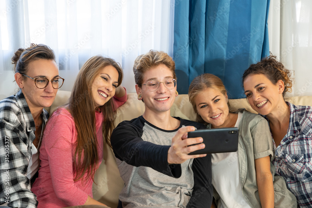 Group of young people making a selfie sitting on a sofa Group of young people making a selfie sitting on a sofa