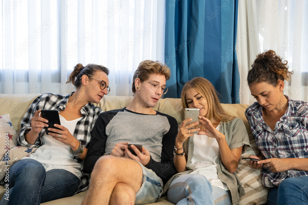 Group of people sitting on a sofa looking at the mobile