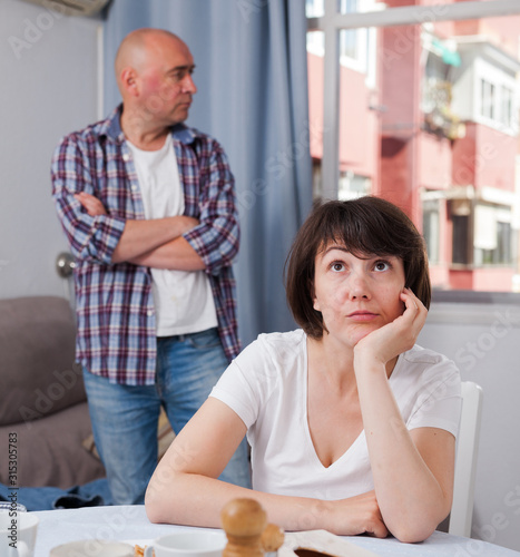 Sad family having difficulties in the living room at home