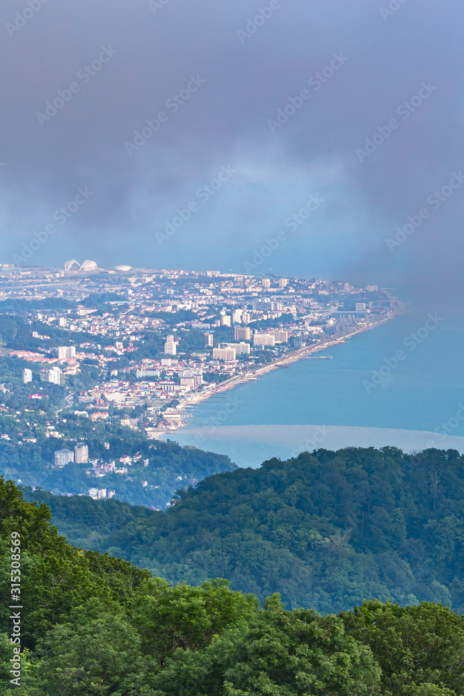 Fototapeta premium the view from the mountains to the resort town of Sochi in summer rainy day
