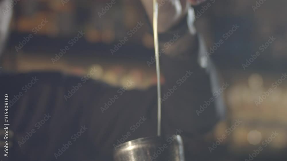Bartender is preparing the cocktail at the bar table. Professional barman prepare a fresh cocktail in the glass at the wooden barstand Bartender is preparing the cocktail at the bar table. Professional barman prepare a fresh cocktail in the glass at the wooden barstand