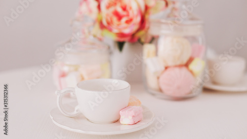 White cup with marshmallows. Romantic breakfast. Concept of holiday, birthday, Easter, International Womens Day. Feminine flat lay