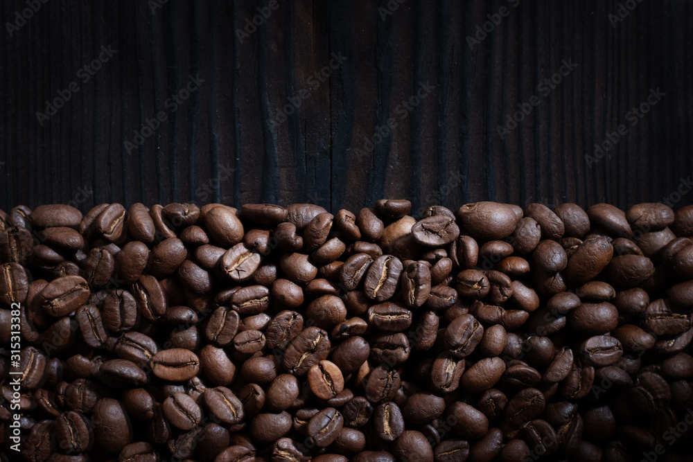 Coffee beans on wood background Coffee beans on wood background