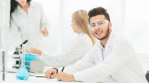 close up.young scientist sitting at his Desk in the laboratory