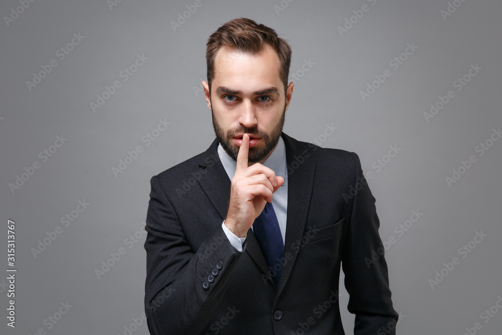 Young business man in classic suit shirt tie posing isolated on grey ...