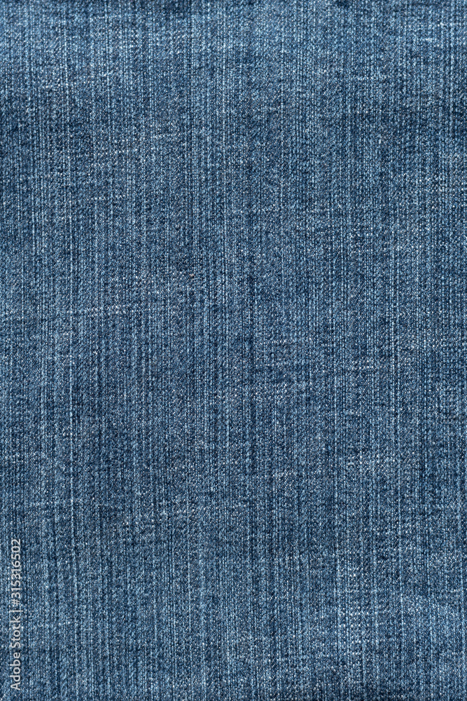 Blue denim textured background. Closeup texture and pattern of jeans fabric Blue denim textured background. Closeup texture and pattern of jeans fabric