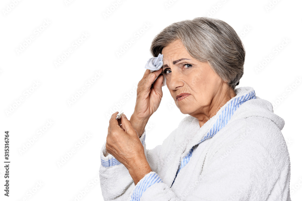 Serious senior woman with headache, isolated on white