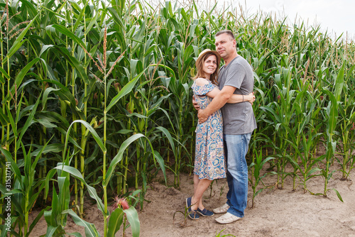 pair of lovers canoodle in the corn field