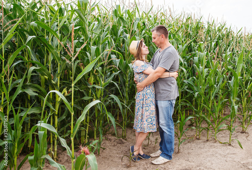 pair of lovers canoodle in the corn field