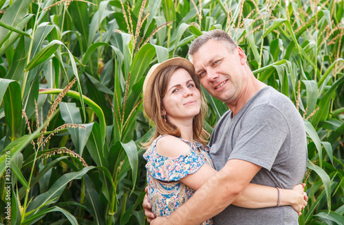pair of lovers canoodle in the corn field